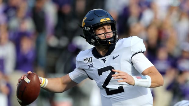 West Virginia Mountaineers quarterback Jarret Doege (2) drops back to pass during the first quarter of a game against the Kansas State Wildcats at Bill Snyder Family Stadium.